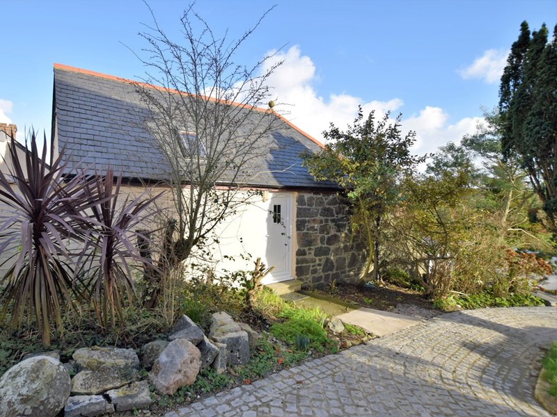 Woodpeckers Cottage, a converted stone barn with cobbled path